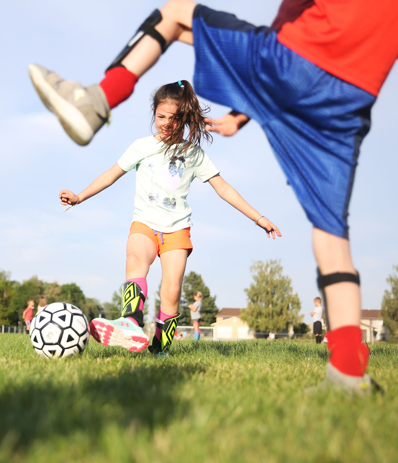 Eleanor Straessler, 8, kicks the ball to her row of players